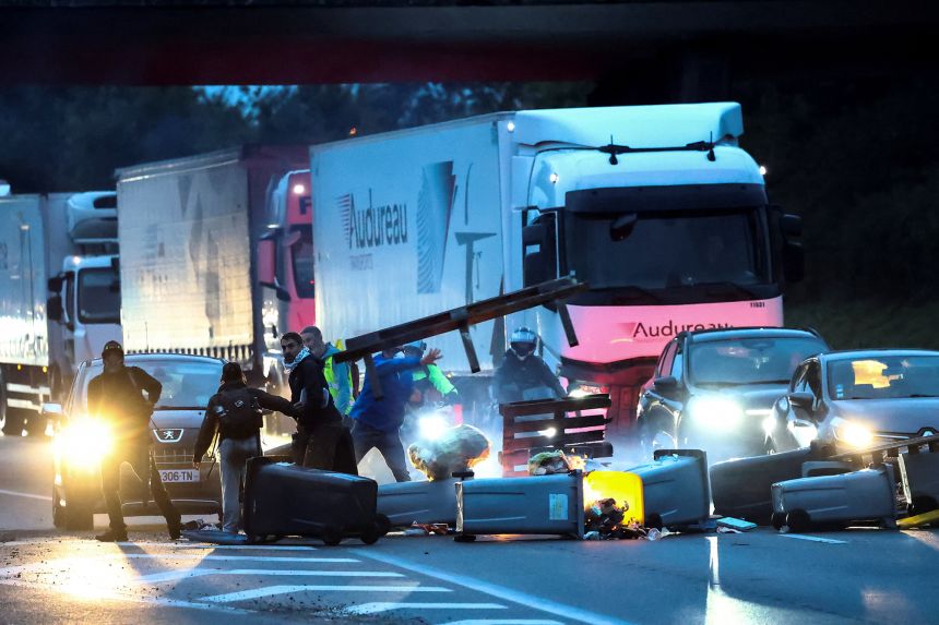 Demonstrators throw garbage containers and other objects to block traffic on the ring road in Nantes as part of the "Block Everything" protests on Wednesday.