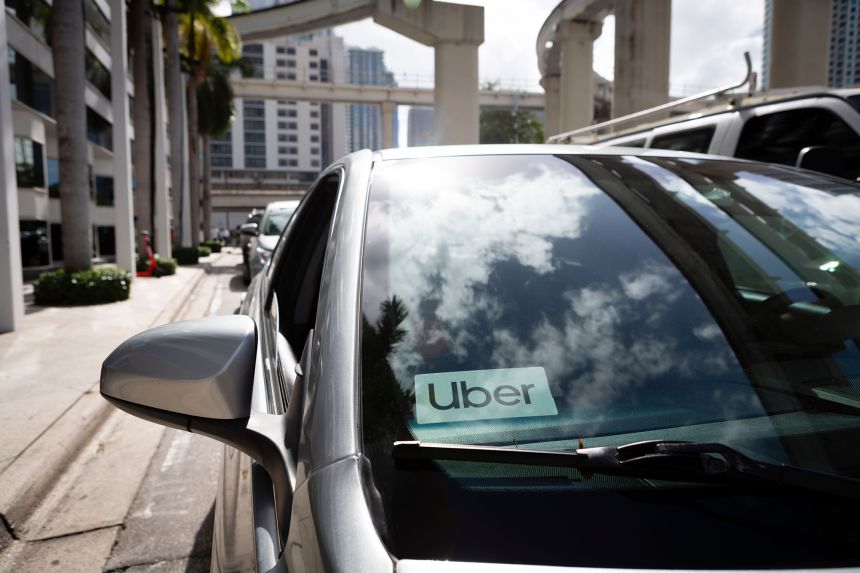 An Uber sticker is seen on a car windshield on the street in downtown Miami on January 9, 2020.