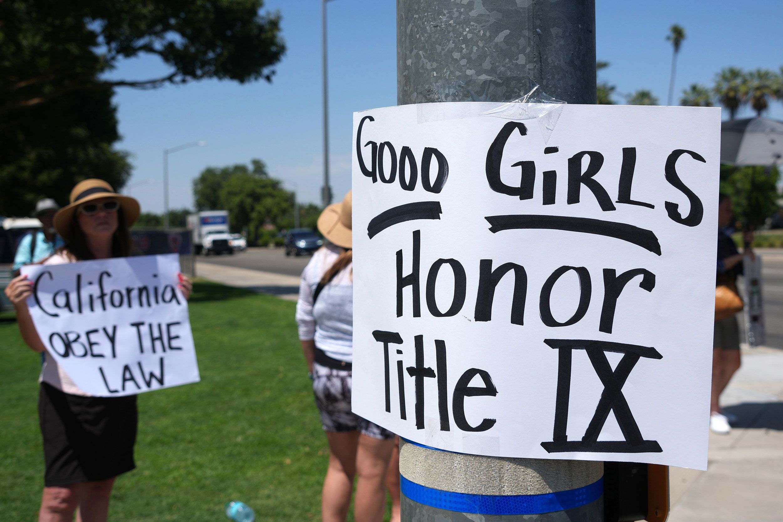 People protest during the CIF State Track and Field Championships at Veterans Memorial Stadium on May 30 in Clovis, California.