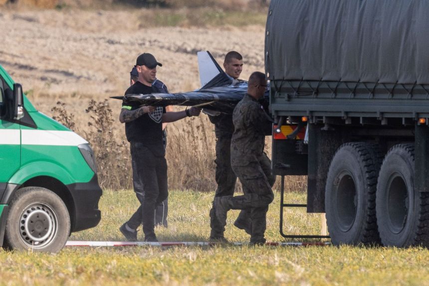 Polish National Territorial Defense Forces at the crash site of a Russian drone in the village of Wohyn, eastern Poland, on September 10.